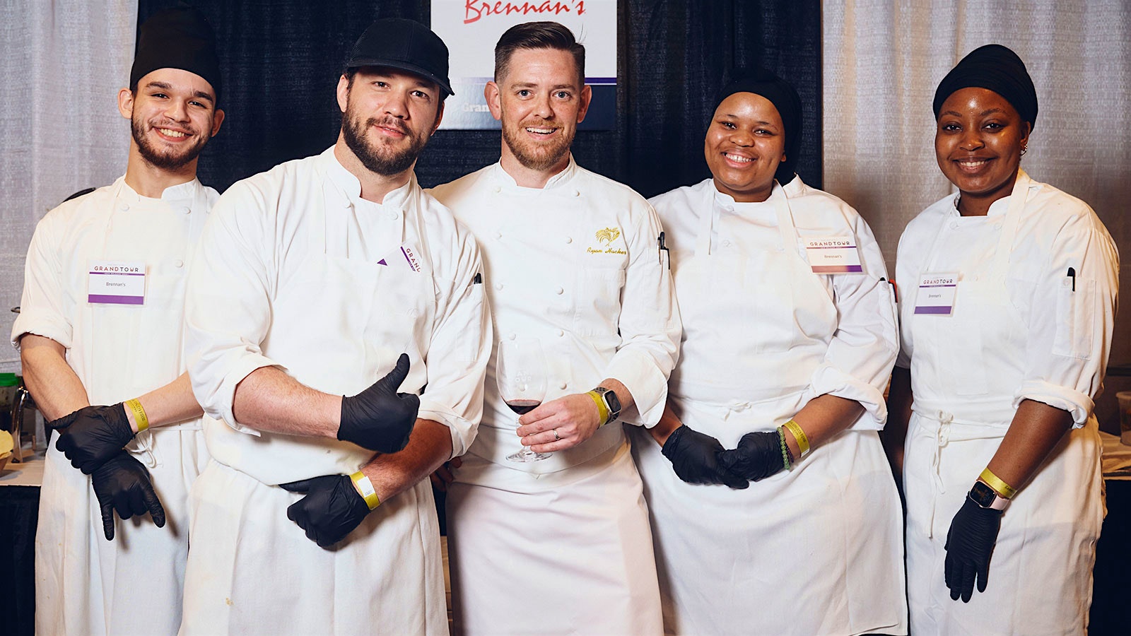  Brennan’s chef Ryan Hacker, center, and his team at the Wine Spectator Grand Tour in New Orleans.